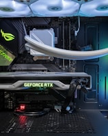 A high-end gaming or performance PC interior equipped with RGB lighting and multiple cooling fans. The graphics card prominently displayed is a GeForce RTX model, with branding visible. The setup includes neatly managed cables and a liquid cooling system.